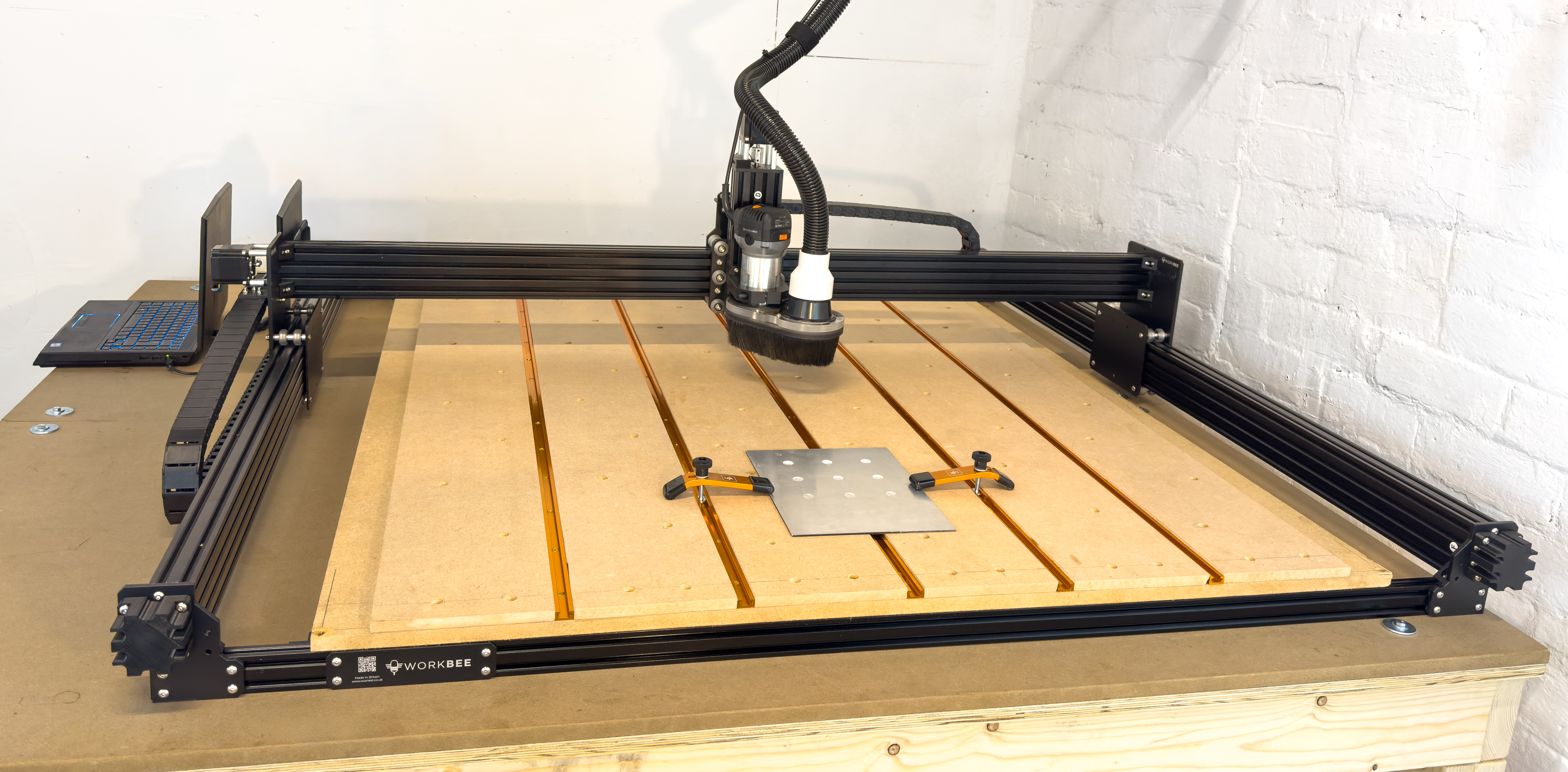 Large-format CNC router with aluminium plate clamped on the work bed